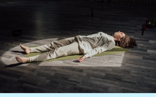 woman laying down on the floor in meditation